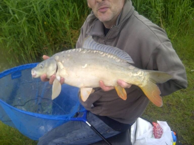 Simon Newcombe with a carp during a fishing trip